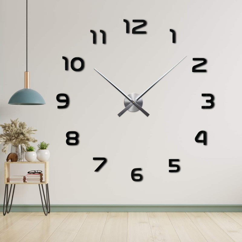 Hodiny bez rámu s centrálnym mechanizmom a dlhými ručičkami.